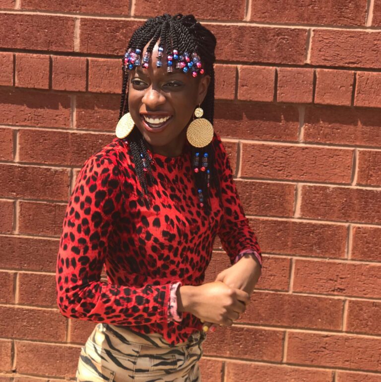 Young woman with a red cheetah shirt and a zebra printed skirt.